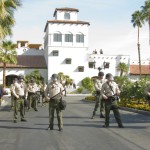 Riverside County Sheriff officers guard the entrance to a Rancho Mirage, California luxury resort where the Koch brothers held their January 2011 political strategy confab.