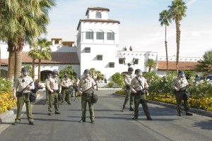 Riverside County Sheriff officers guard the entrance to a Rancho Mirage, California luxury resort where the Koch brothers held their January 2011 political strategy confab.